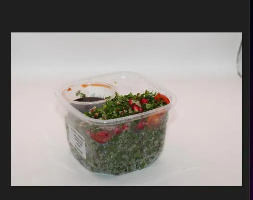 Fresh tabbouleh salad cup with tomato and herb dressing